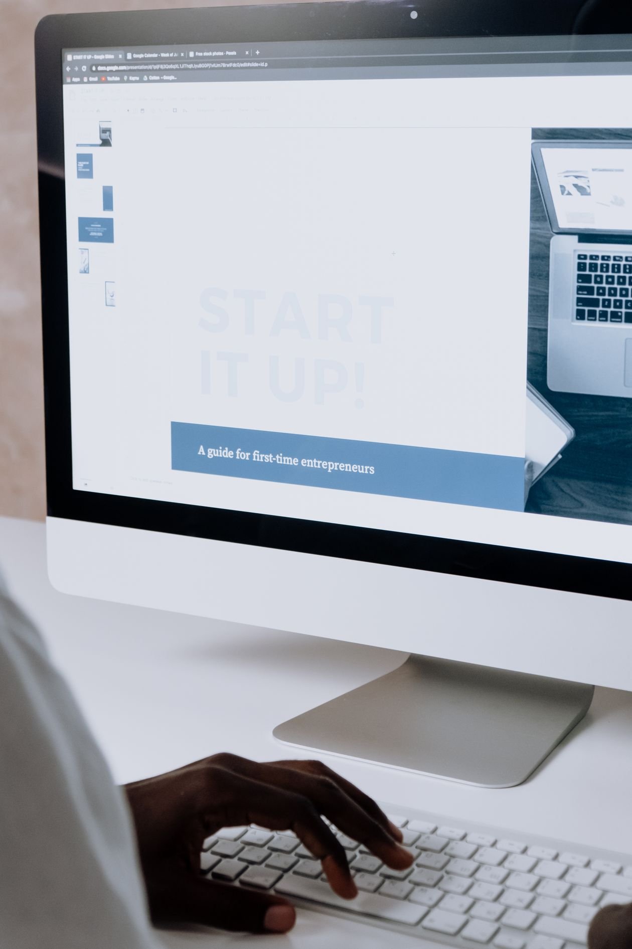 Person planning a website page layout on a desktop computer
